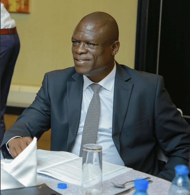 a man in a meeting with papers in front of him